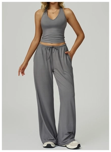 Detail of dark grey halter sports vest and wide-leg trousers in high-stretch knit fabric