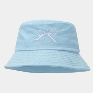 Detail of light blue bucket hat featuring white bow embroidery and reinforced brim stitching