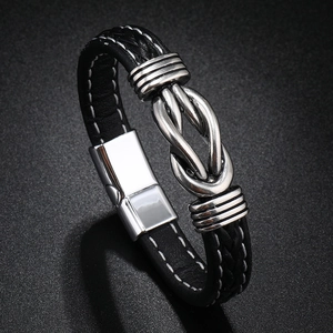 Close-up of black braided leather bracelet with silver infinity symbol and magnetic clasp