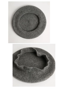 Detailed top view of a dark grey wool beret showing soft texture and folded structure