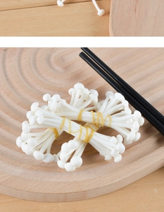Detailed view of realistic PVC enoki mushrooms with rubber band detail on wood tray