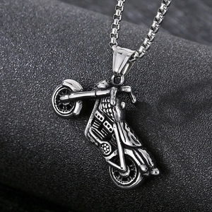 Detailed view of a vintage silver motorcycle pendant with an intricate engine design