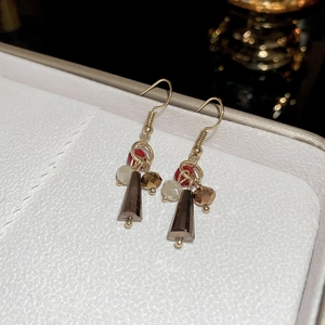 Macro shot of fishtail pearl earrings with colorful beads and trapezoid pendant detail