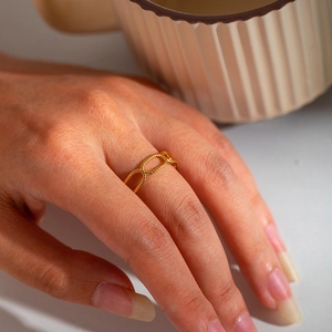 Close-up of a 18K gold-plated open hollow geometric ring worn on a finger