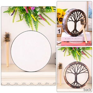 Detailed view of white shaman drum with tree of life carving and a wooden mallet