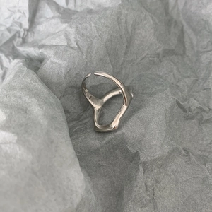 Macro shot of irregular geometric silver ring with S925 hallmark on grey texture