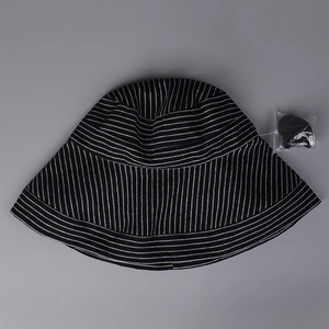 Detail view of striped cotton linen sun hat with an adjustable black windproof chin strap