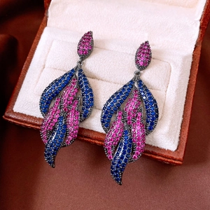 Macro detail of vintage teardrop earrings with pink and blue zircon in gun black finish