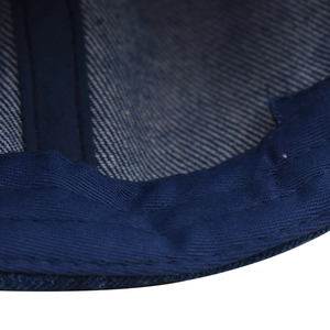 Detailed stitching of the sweatband and inner seams of this washed denim baseball cap