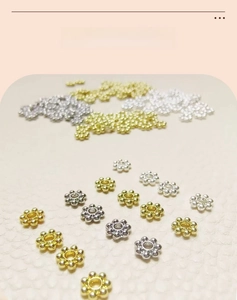 Detailed macro of 18k real gold plated snowflake flower spacer beads for DIY jewelry making