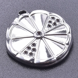 Macro shot of a round silver pendant with radial patterns and sparkling crystal rhinestones