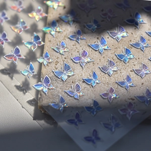 Macro shot of laser holographic butterfly stickers with colorful iridescent effects