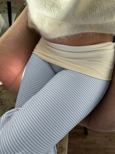 Detailed close-up of blue and white striped high-waisted trousers with elastic fabric
