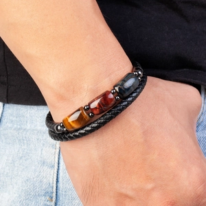 Men's braided leather bracelet featuring tiger eye stone beads on a male wrist