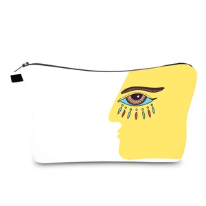 White and yellow canvas travel cosmetic bag featuring a unique evil eye illustration
