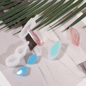Detail of resin silicone molds with geometric stone pendants and crystal DIY finished pieces