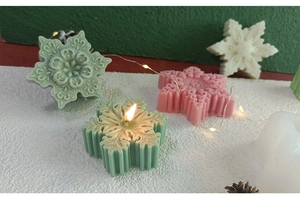 Close-up of snowflake scented candles with 3D embossed texture in various colors
