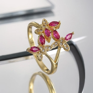 Elegant gold butterfly ring with marquise-cut red rubies and sparkling zircon stones