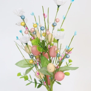 Detail of Easter egg floral stems with white flowers and pearly berries for home decor
