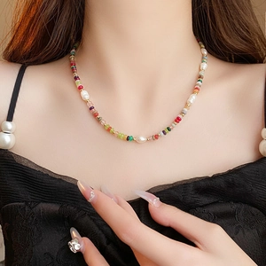 Detail of colorful baroque pearl necklace with multicolor beads on a model