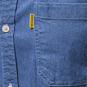 Men's casual long sleeve denim shirt with chest pocket and distinctive woven label