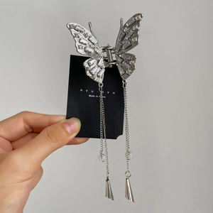 Silver butterfly hair claw clip with rhinestones and long tassel chains for elegant styling