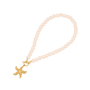 Elegant pearl necklace with a golden starfish pendant and toggle clasp on a white background