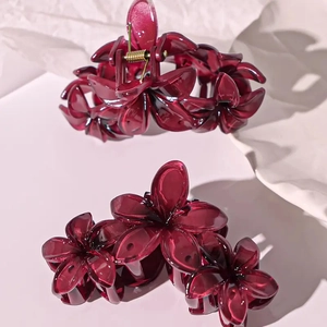 Elegant burgundy floral shark hair claw clip with glossy finish and gold spring