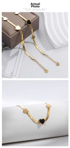 Flat gold snake chain bracelet featuring multicolored heart charms with shell texture