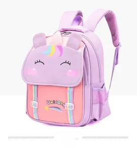 Close-up of pink unicorn backpack with 3D ears, rainbow tassel, and waterproof fabric
