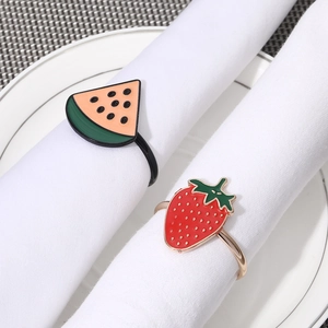 Watermelon and strawberry alloy napkin rings with colorful enamel on white cloth