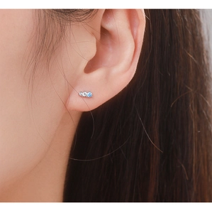 Detail of a small S925 sterling silver earring with blue and clear zircon stones