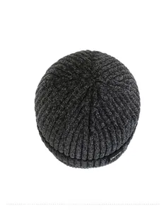 Close-up of dark grey knit beanie with sport label and soft chenille texture detail