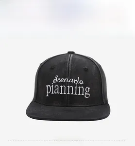 Macro shot of white Scenario Planning embroidery on black cotton twill flat brim cap