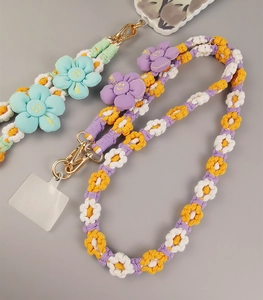 Detail of handmade floral braided phone lanyards with metal clasps and cotton weaving