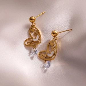 Golden heart drop earrings with white shell inlay and clear crystal on beige silk