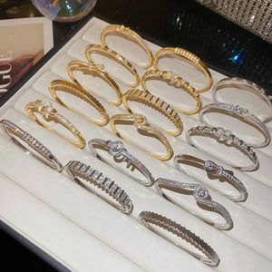 Detailed close-up of 18k gold plated bracelets with zircons in a jewelry box