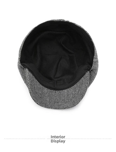 Detail view of the black fabric lining and neat interior stitching of herringbone newsboy cap