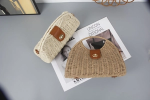 Detail of woven straw handbags with leather straps and gold metal twist locks