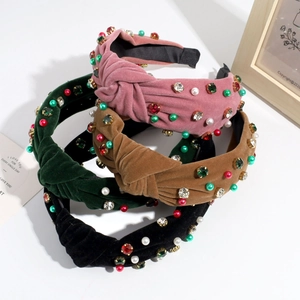 Detail of four velvet knotted headbands with colorful rhinestones and pearls