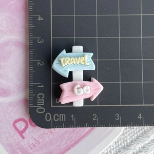 Macro view of a 2.5cm resin travel sign charm for DIY crafts and phone case decor