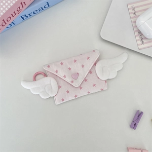 Detailed view of a pink wing coin purse with star patterns and a heart button