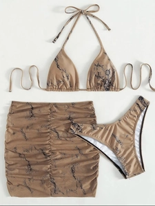 Detailed flat lay of marble print bikini three-piece set with a matching ruched mini skirt