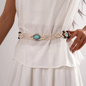Detail of bohemian woven waist chain with turquoise gemstone and wooden beads