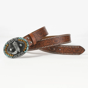 Detail of bohemian brown leather belt with embossed patterns and turquoise buckle