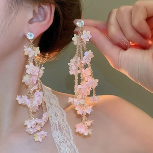 Detail of pink floral tassel earrings featuring gradient petals and crystal bead fringe