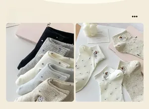 Detailed view of women's cotton socks featuring cute puppy embroidery and dot patterns