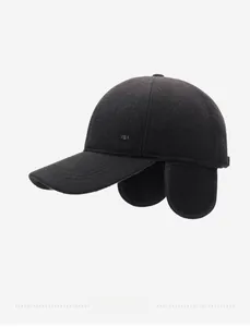 Detail view of winter baseball cap with ear flaps and SPORT metal logo on side