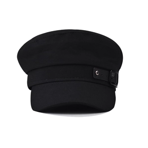 Classic black cotton baker boy hat with leather strap and metal buckle on white background