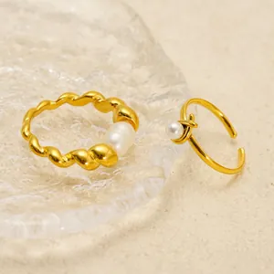 Elegant gold-plated stainless steel rings with round natural freshwater pearls on textured stone